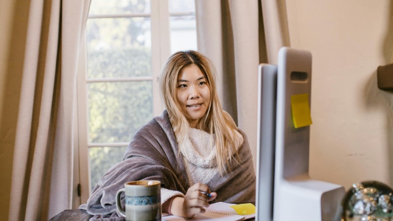Asian woman studying online at home with a cozy setup and a computer., tags: sprache und - pexel